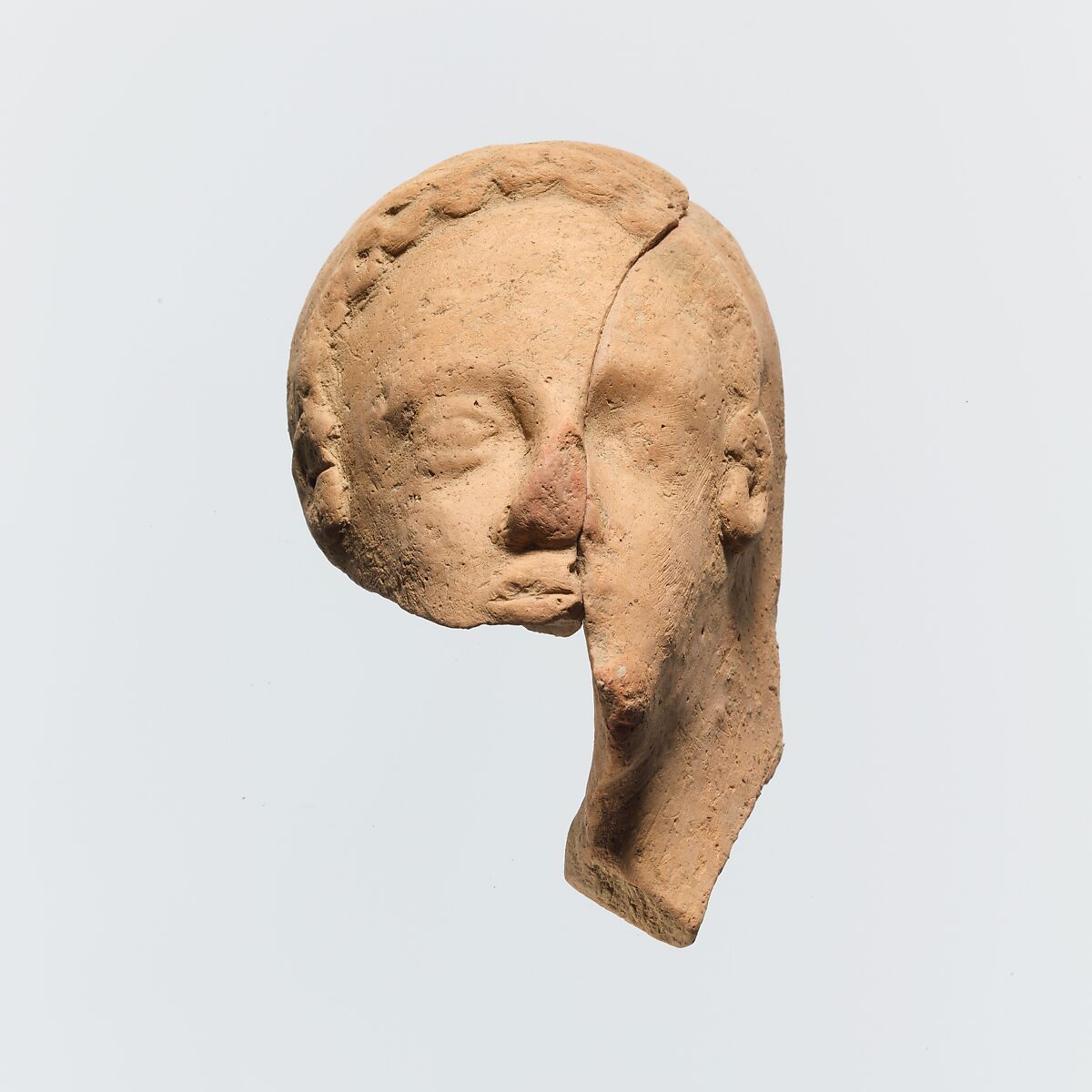 Fragmentary head of a woman, Terracotta, Greek, Cretan 