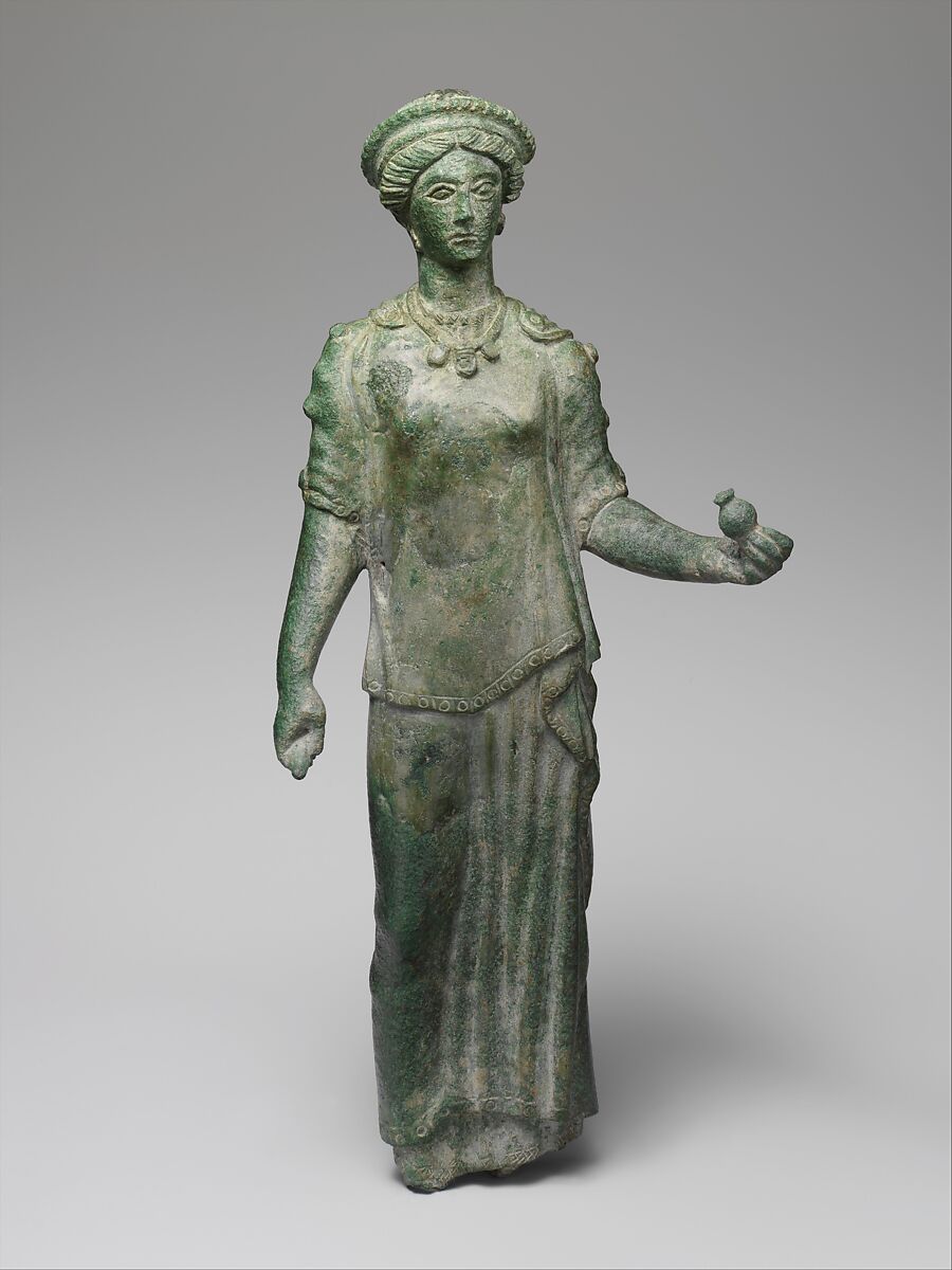 Persephone and pomegranate: Bronze statuette of a female votary.