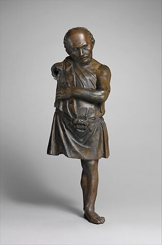 Bronze statuette of an artisan with silver eyes