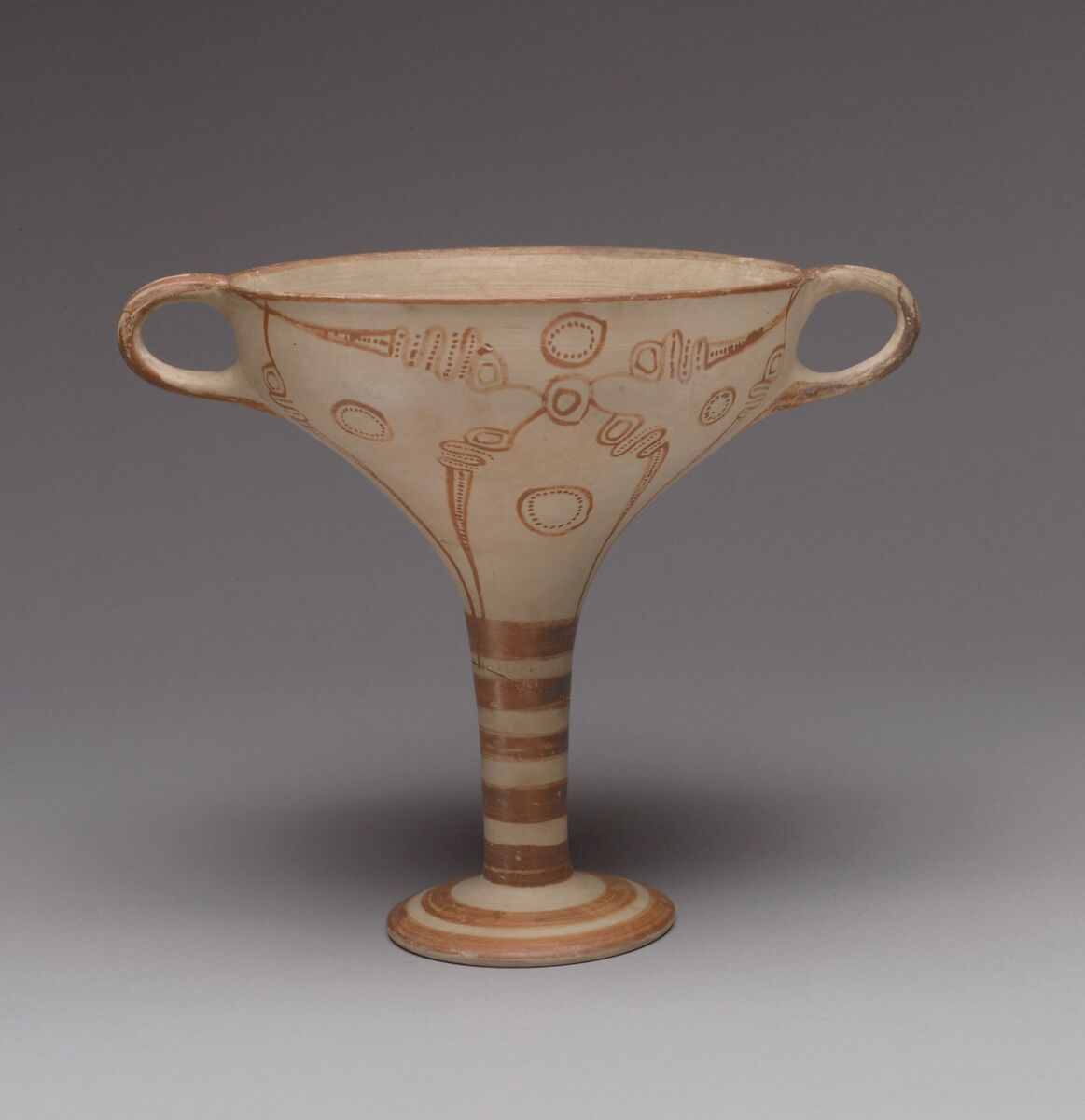 Terracotta stemmed cup with murex decoration