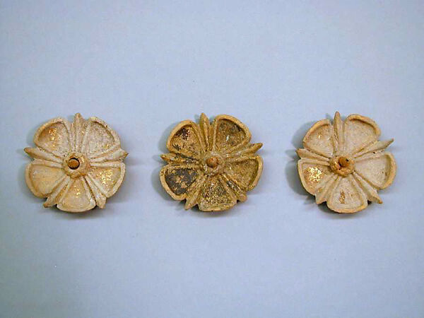 Three gilded terracotta appliqués