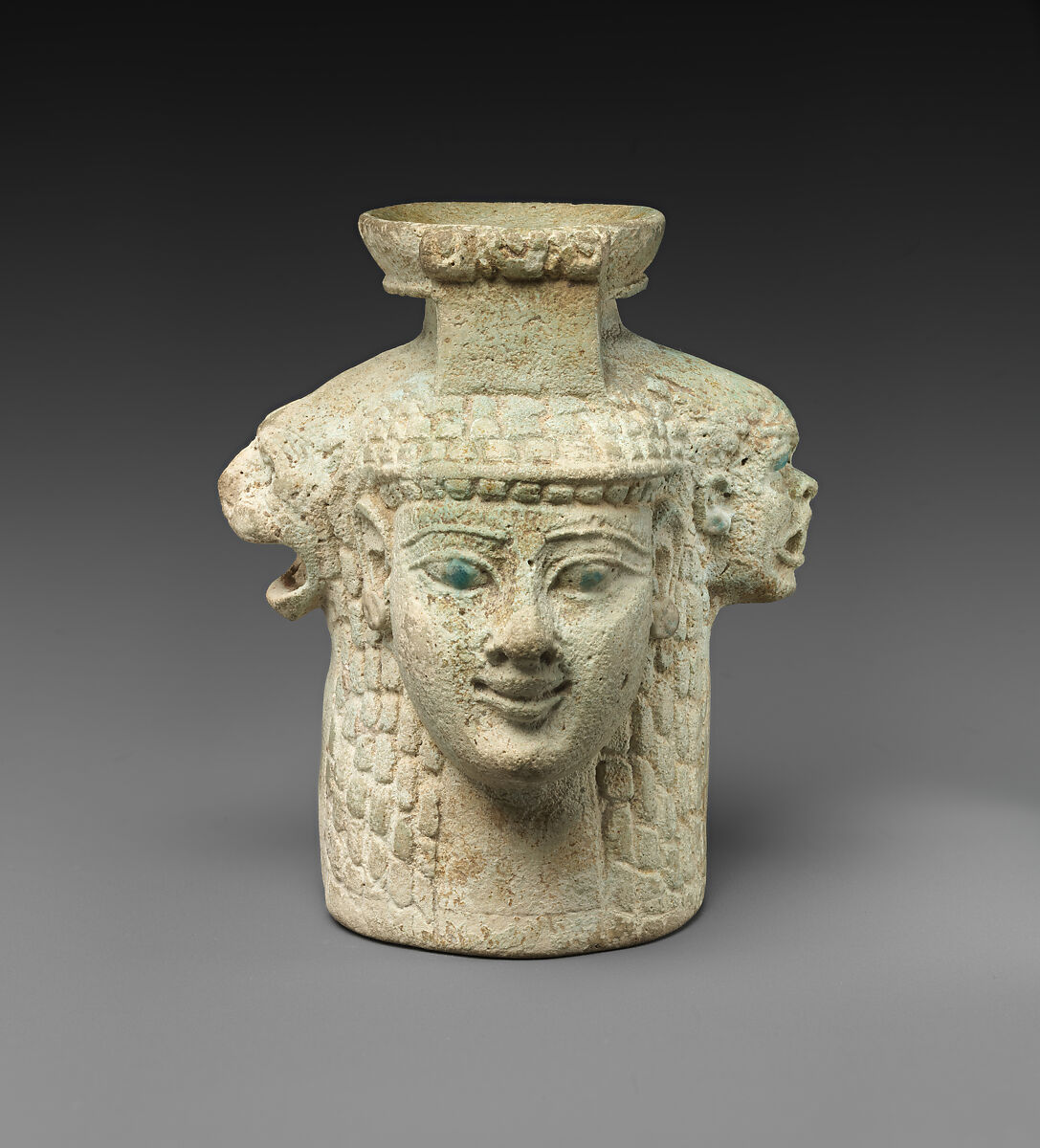 Faience aryballos (perfume vase) in the form of four heads, Faience, East Greek