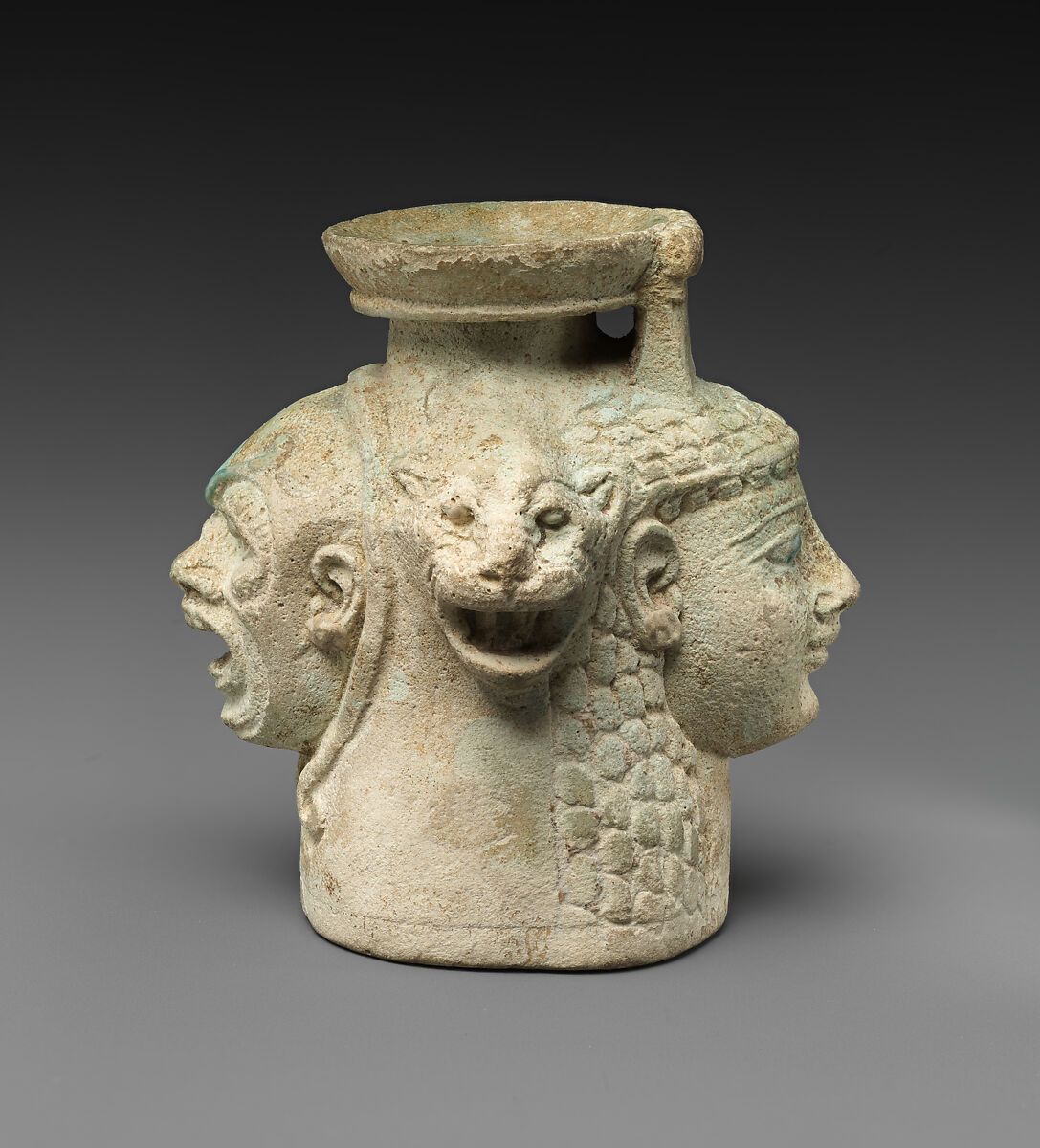 Faience aryballos (perfume vase) in the form of four heads, Faience, East Greek