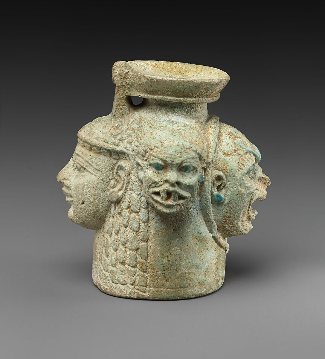 Faience aryballos (perfume vase) in the form of four heads, Faience, East Greek