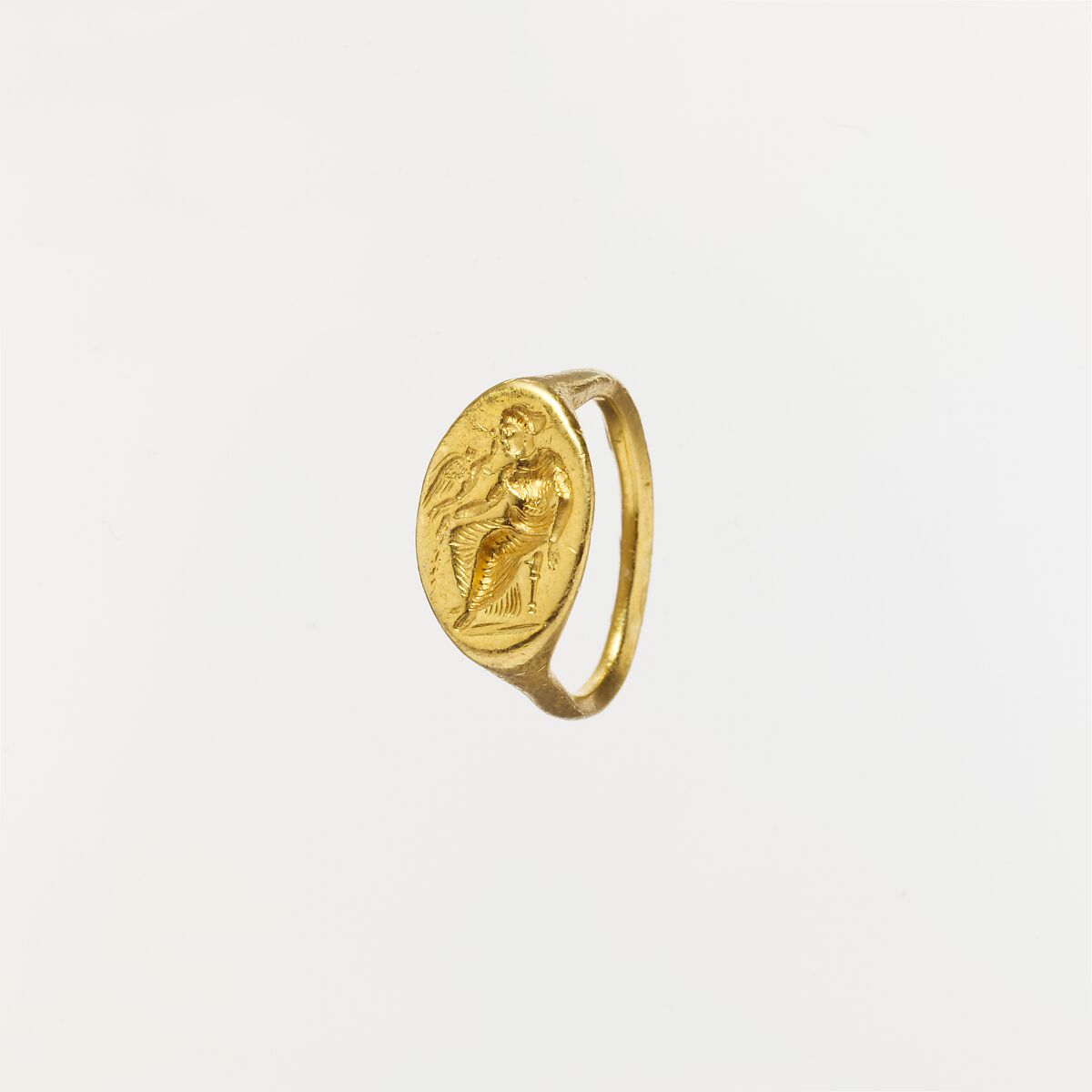 Gold ring with intaglio of seated woman and flying Eros, Gold, Greek 