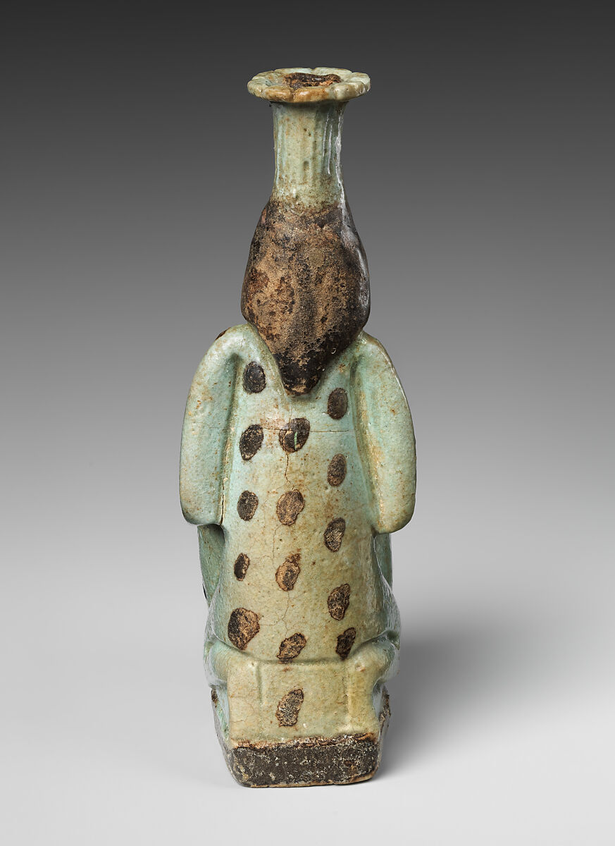 Faience double-spouted vessel in the form of a kneeling woman holding a jar, Faience, East Greek