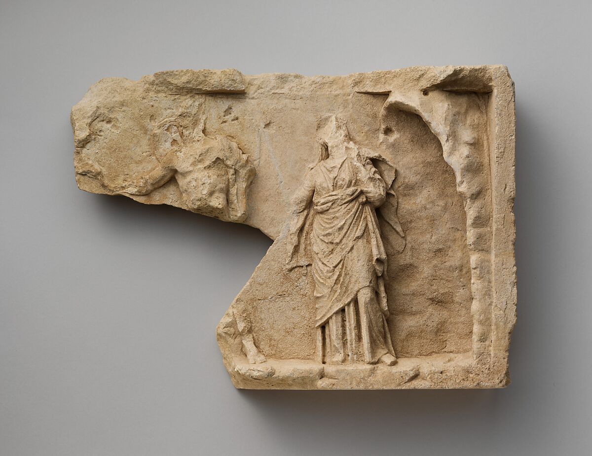 Fragment of a limestone relief with two standing figures