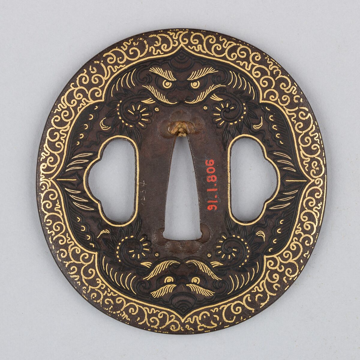 Sword Guard (<i>Tsuba</i>) Depicting Biting Lion Heads (<i>Shikami</i>) and Arabesques (獅噛唐草図南蛮鐔), Iron, gold, copper-gold alloy (<i>shakudō</i>), Japanese