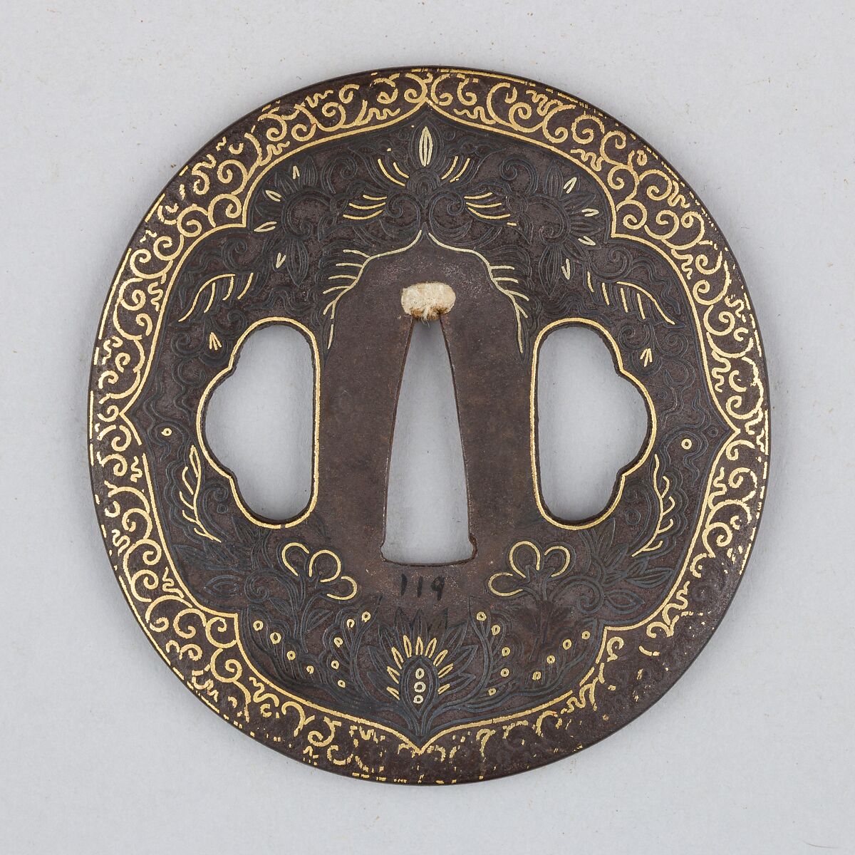 Sword Guard (<i>Tsuba</i>) Depicting Biting Lion Heads (<i>Shikami</i>) and Arabesques (獅噛唐草図南蛮鐔), Iron, gold, copper-gold alloy (<i>shakudō</i>), Japanese