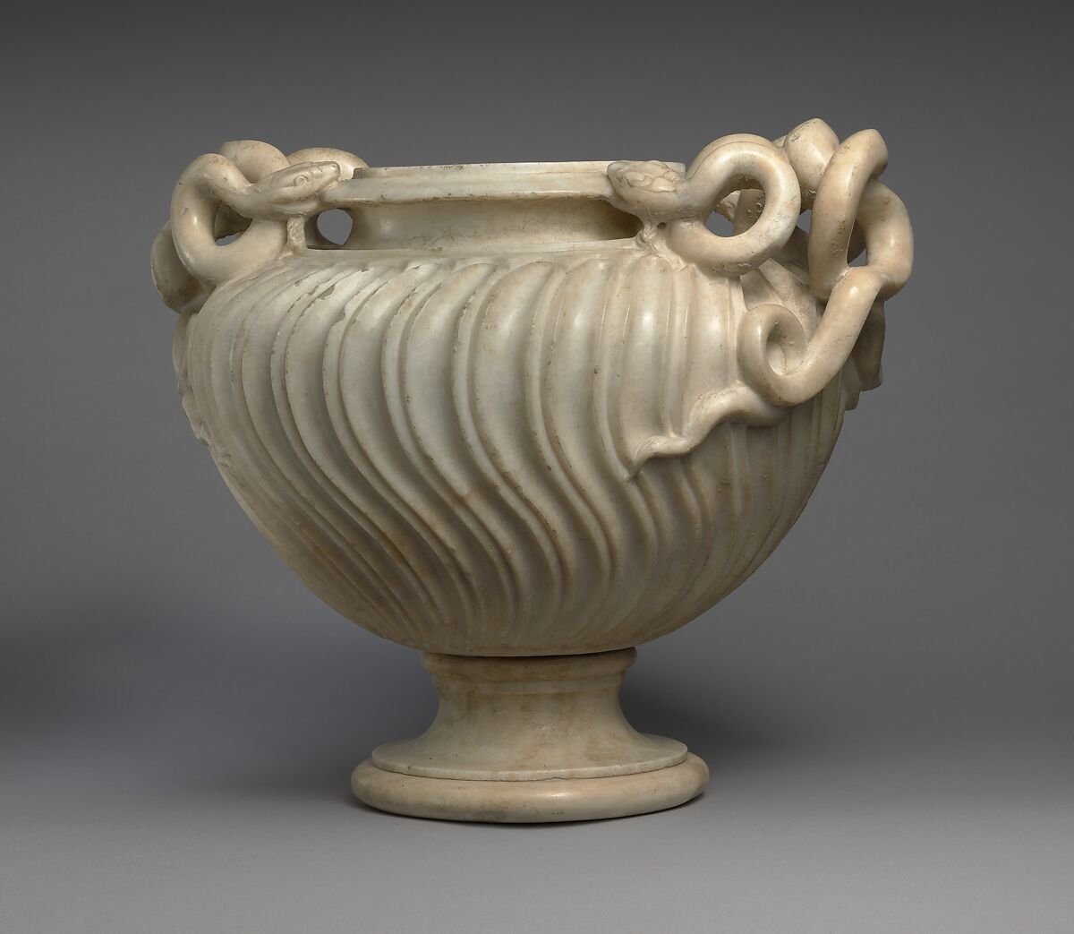 Marble strigilated vase with snake handles