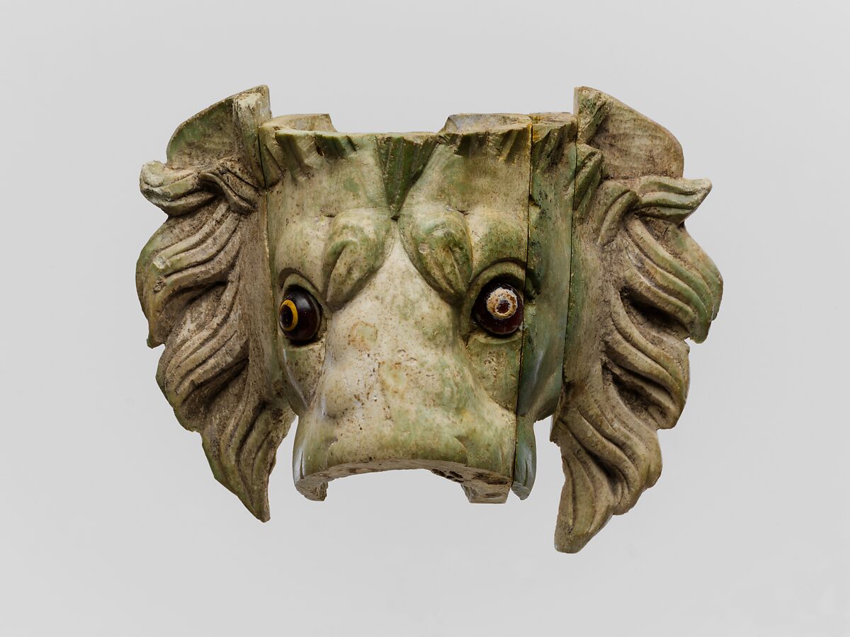 Bone lion's head protome with glass eyes, bone and glass, Roman 