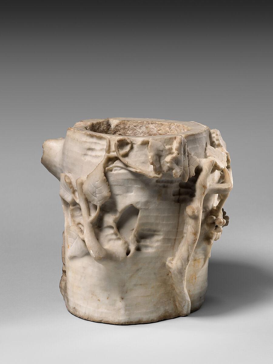 Marble cinerary urn in the form of a tree stump with leaves and grapes, Marble, Roman