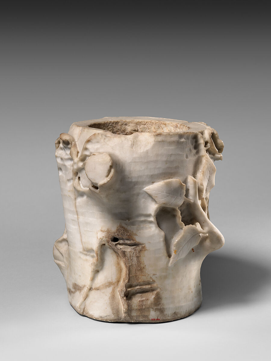 Marble cinerary urn in the form of a tree stump with leaves and grapes, Marble, Roman