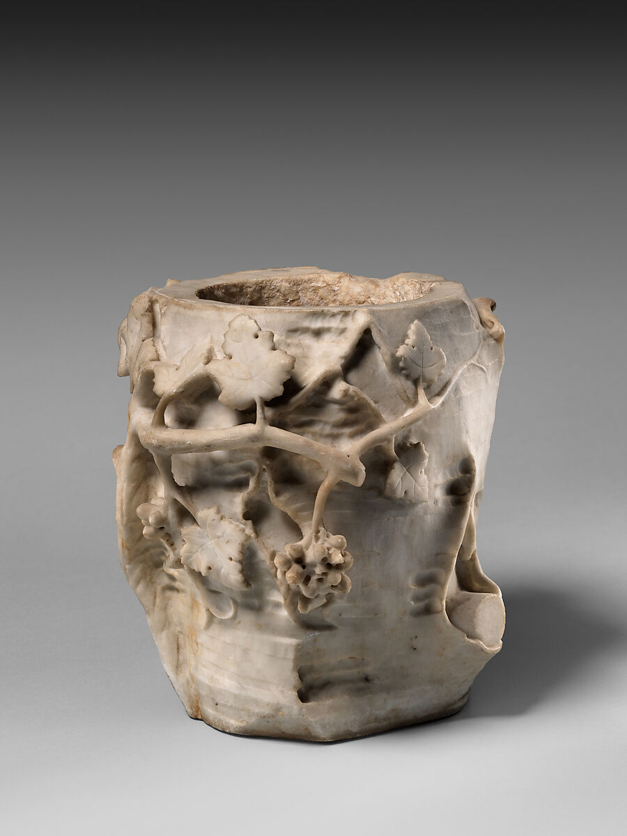 Marble cinerary urn in the form of a tree stump with leaves and grapes, Marble, Roman 