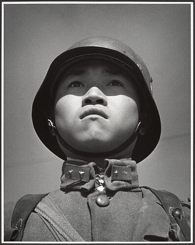 A fifteen-year-old stands at attention before his company leaves for the front and the decisive Sino-Japanese battles of the year. Hankow, March