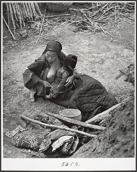 After the bombardments, this mother is one of many who keep alive by eating herbs and roots, Taiherhchwang, Robert Capa  American, born Hungary, Gelatin silver print