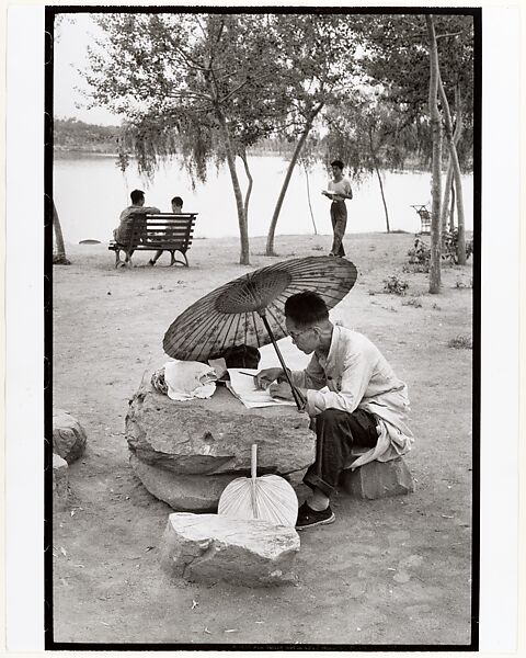 A Professor Corrects His Class Papers by the Lake in the Newly Build King Chan Park, Peking, Henri Cartier-Bresson (French, Chanteloup-en-Brie 1908–2004 Montjustin), Gelatin silver print 