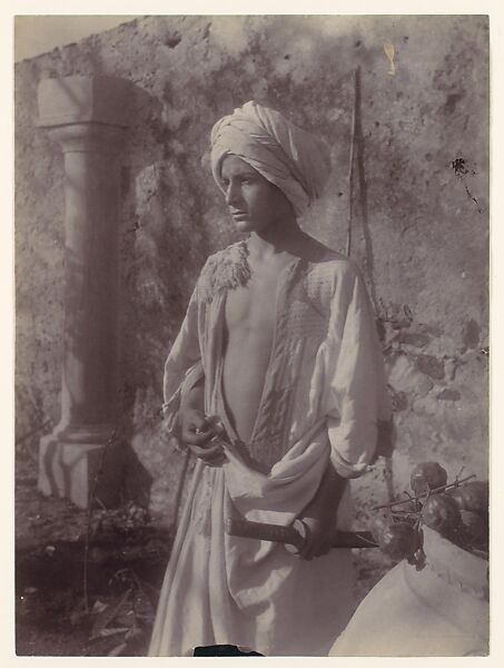 [Young Man in White Robe and Head Gear Holding Scabbard, Sicily, Italy], Wilhelm von Gloeden (Italian (born Germany), 1886–1931), Albumen silver print from glass negative 