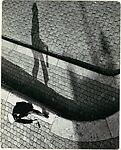 [Pedestrian with a Bottle in Hand, Viewed from Above], Piet Spoor (Belgian, 1897–1979), Gelatin silver print 