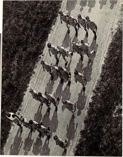[Boys Marching on a Road, from Above]