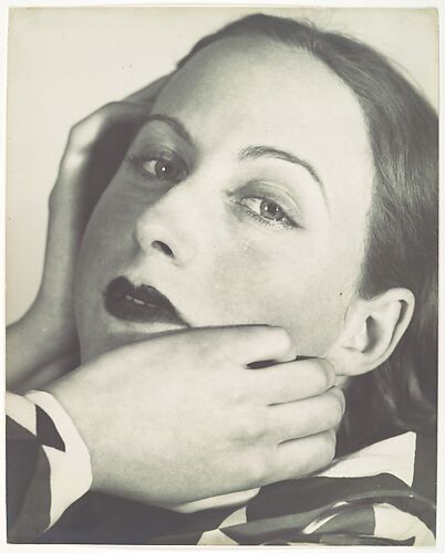 [Portrait Composition: Close-up, three-quarter view of woman with hands at her face]