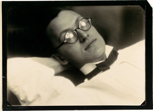 [Diagonal View of Young Man Wearing Glasses, Wing Collar, and Bow Tie]