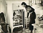 [Advertisement for Westinghouse Refrigerators: Woman Putting Groceries Away]
