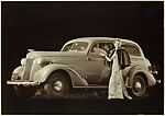 [Advertisement for Chevrolet: Woman in Evening Gown in front of a Chevrolet]