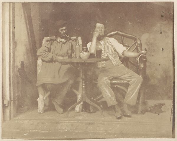 [Two Men Seated at a Table]