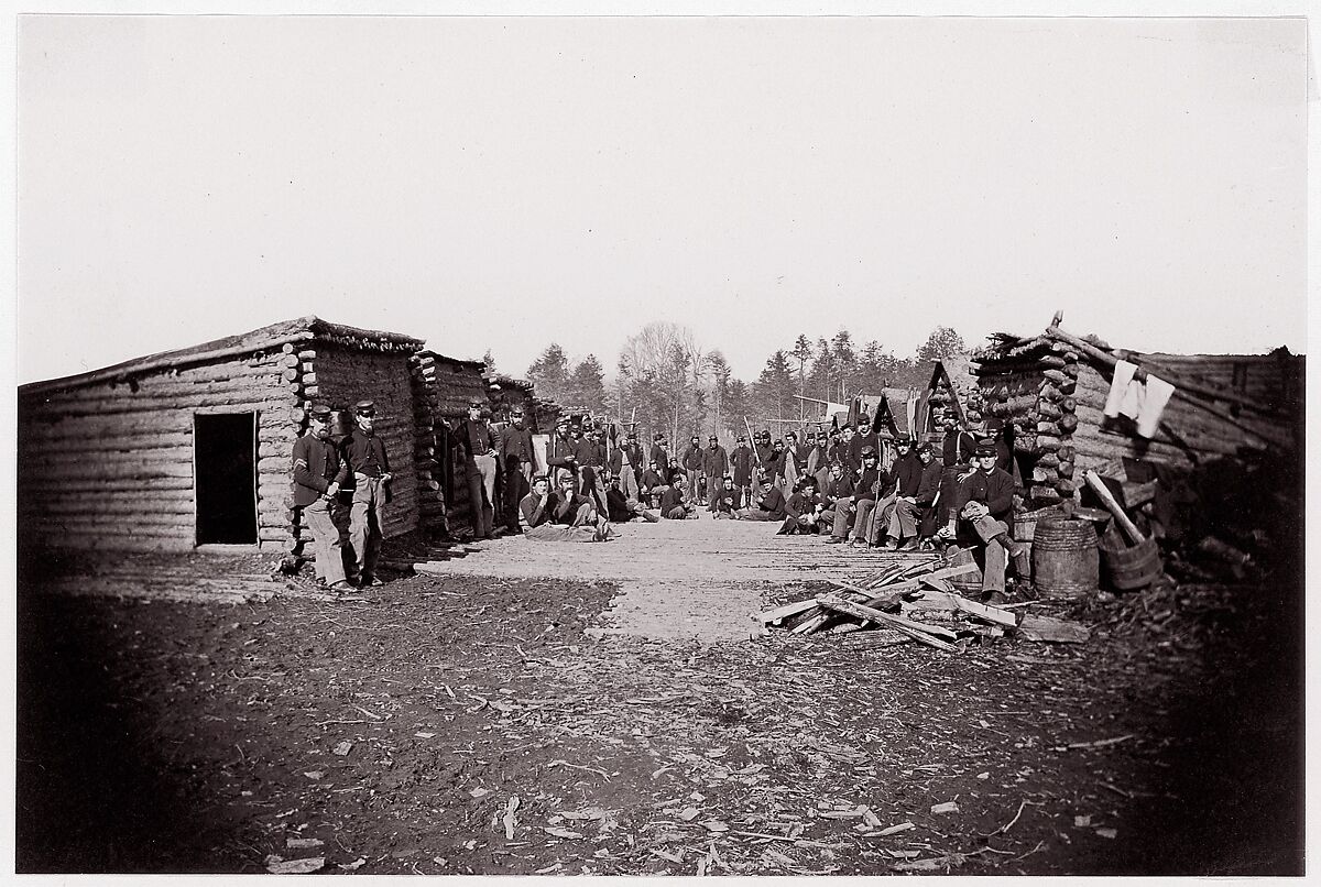 [Winter Quarters, troops with row of cabins].  Brady album, p. 128, Unknown (American), Albumen silver print from glass negative 