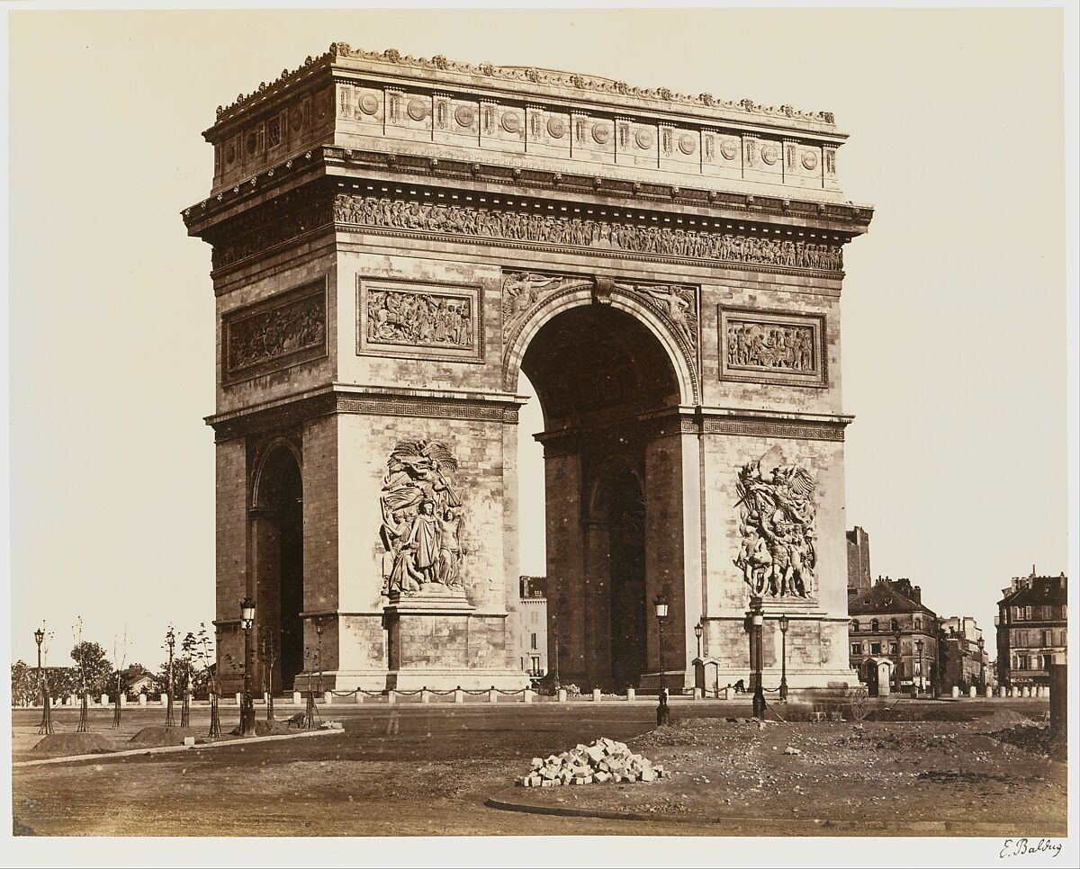 Arc de triomphe de l'Ètoile taken in an old black and white photo. The structure consists of a single arch that sits in Paris, France. 