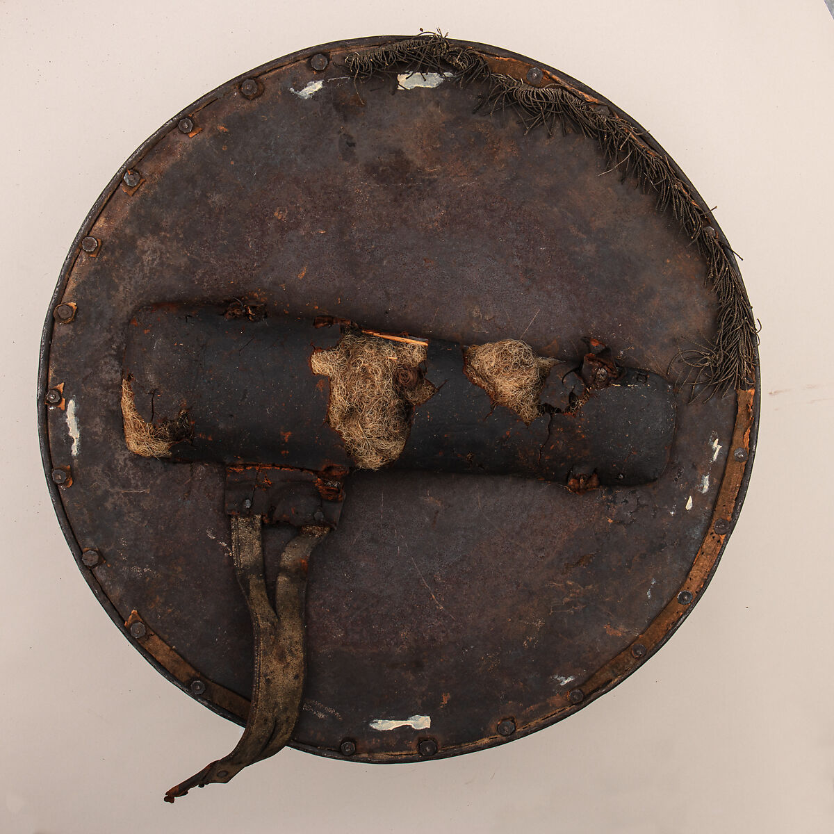 Shield (<i>Rotella</i> or <i>Brocchiere</i>) from an Armor Garniture of the Völs-Colonna Family, Steel, copper alloy (brass), leather, horsehair, textile, Italian, Milan