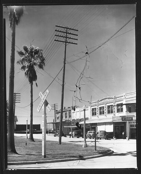 [Parked Cars and Shopfronts on Main Street with Railroad Crossing Sign and Telephone Pole in Foreground, Morgan City, Louisiana], Walker Evans (American, St. Louis, Missouri 1903–1975 New Haven, Connecticut), Film negative 
