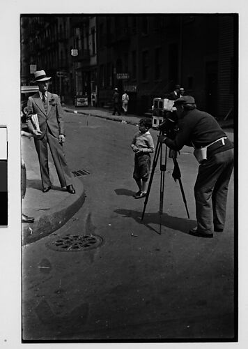 [Two 35mm Film Frames: Tintype Photographer and Man on Street Corner, New York City]
