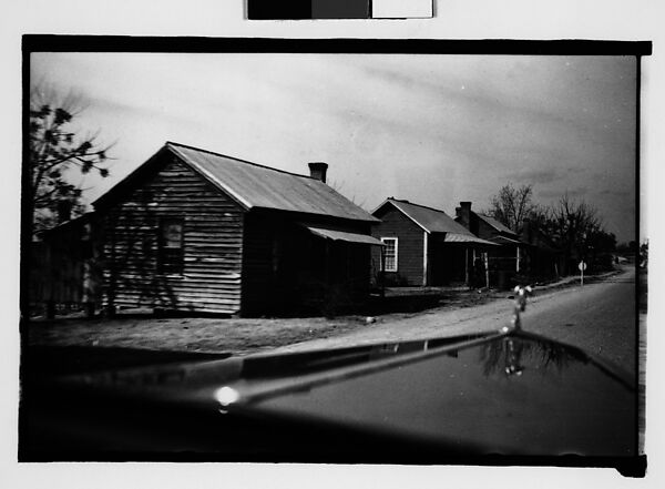 [Wooden Houses by Road with Hood in Foreground, From Automobile, Macon, Georgia]