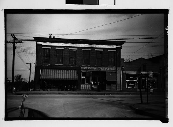 [Cafe and Drugstore on Corner with Men Seated on Bench, From Automobile, Macon, Georgia], Walker Evans (American, St. Louis, Missouri 1903–1975 New Haven, Connecticut), Film negative 