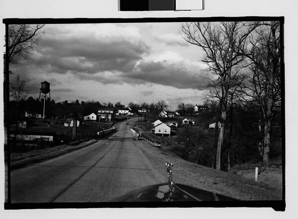 [View of Road with Car Hood in Foreground, From Car, Mobile, Alabama]