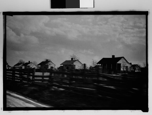 [Wooden Houses by Road Behind Slat Fence, From Moving Automobile, New Orleans Vicinity, Louisiana], Walker Evans (American, St. Louis, Missouri 1903–1975 New Haven, Connecticut), Film negative 