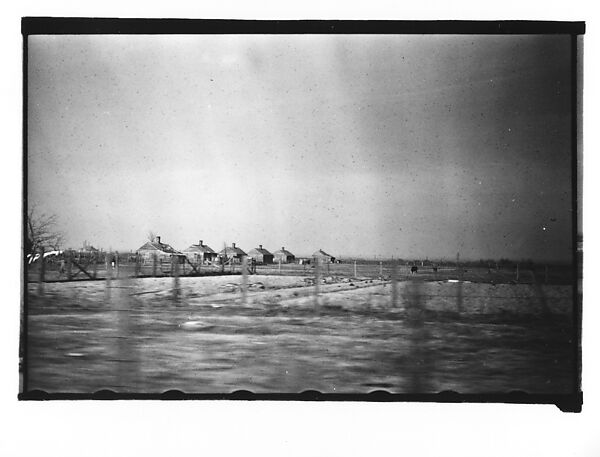 [Row of Wooden Houses in Field, From Moving Automobile, Louisiana]