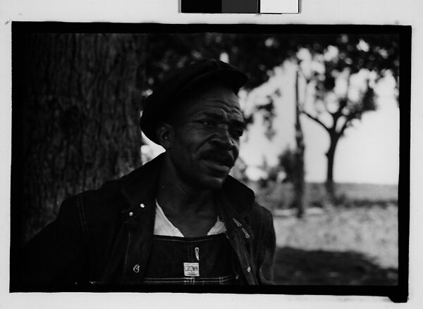 [Man Wearing Cap and Overalls Next to Tree, Hale County?, Alabama]