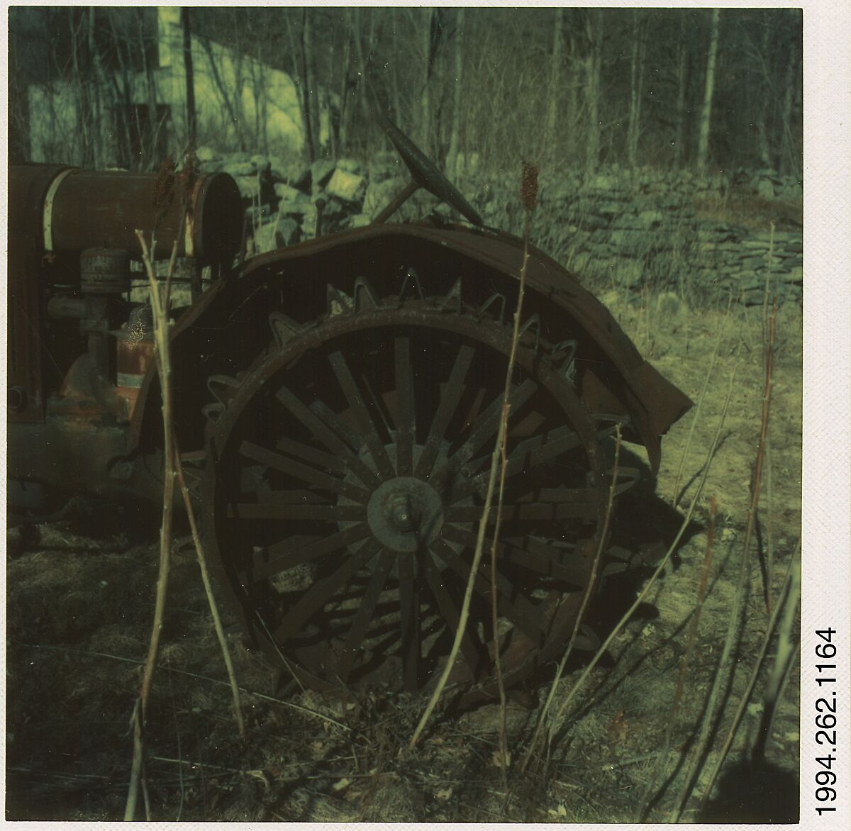 [Auto Junkyard, Old Lyme, Connecticut: Tractor Wheel], Walker Evans (American, St. Louis, Missouri 1903–1975 New Haven, Connecticut), Instant internal dye diffusion transfer print (Polaroid SX-70) 