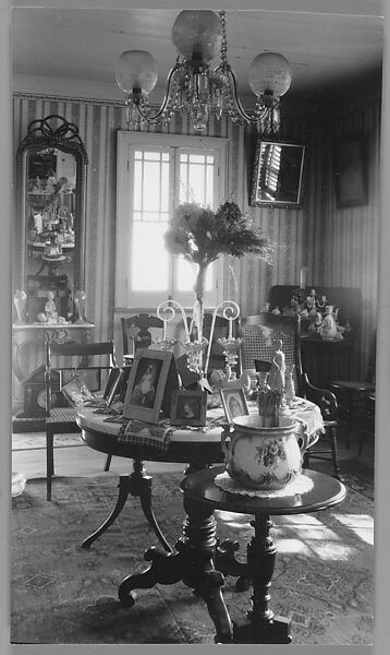 [Domestic Interior with Crystal Chandelier, Mirrors, Round Tables with Framed Photographs], Nancy Naumburg (American), Gelatin silver print 
