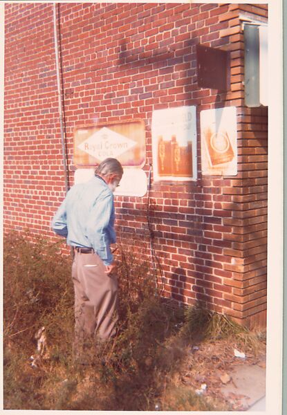 [Walker Evans in Front of Brick Wall with Commercial Signs, Alabama], William Christenberry (American, 1936–2016), Chromogenic print 