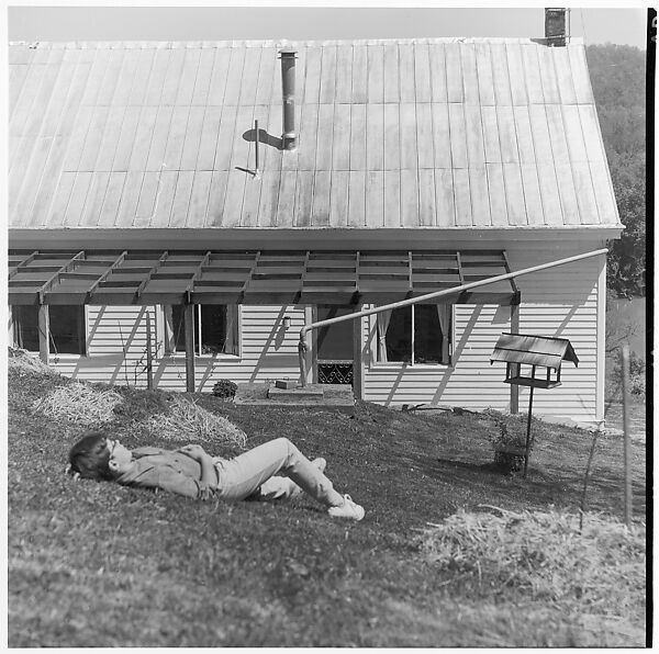 [Boy Lying on Ground in Front of House], Ralph Eugene Meatyard (American, 1925–1972), Gelatin silver print 