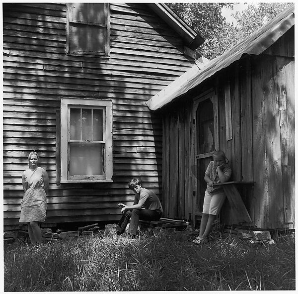 [Woman Leaning Against House Façade, Boy Seated, and Girl Leaning Against Shed], Ralph Eugene Meatyard (American, 1925–1972), Gelatin silver print 