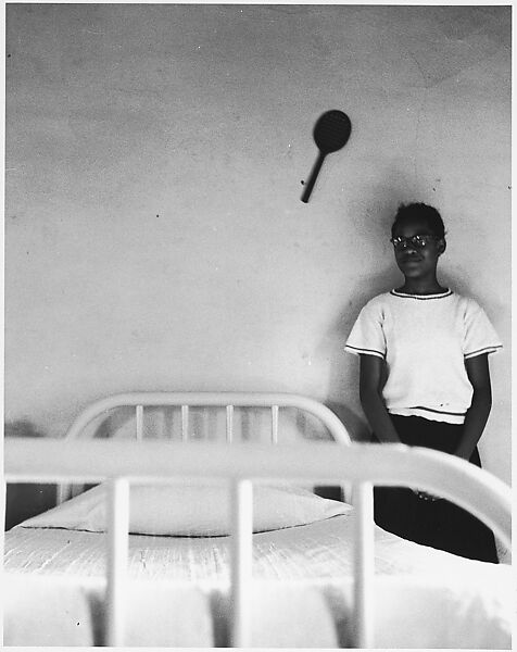 [Girl Standing Next to Bed, Racket on Wall], Ralph Eugene Meatyard (American, 1925–1972), Gelatin silver print 