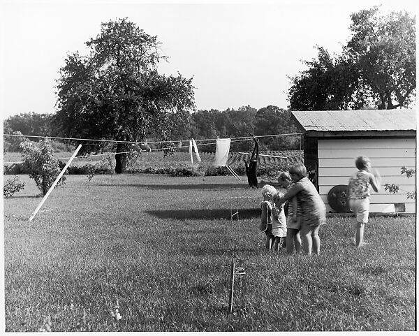 [Four Children Huddled Near Clothesline, One Standing Apart], Ralph Eugene Meatyard (American, 1925–1972), Gelatin silver print 