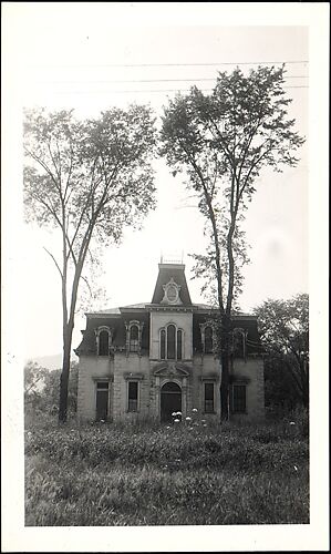 [Brick Second Empire House, Behind Two Trees]