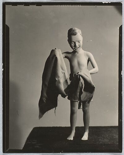 [Painted Plaster Figure of Boy on Beach with Towel]