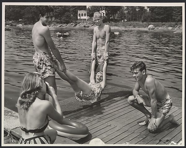 [Eastman Kodak Advertisement: Summer Lake Scene of Teenager with Camera Making a Snapshot of Her Friends in Bathing Suits on a Dock]